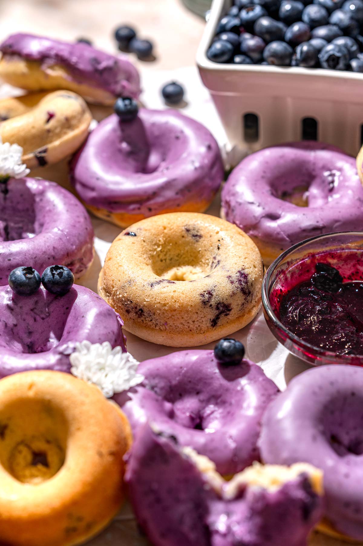 vegan baked blueberry donuts with blueberry glaze.
