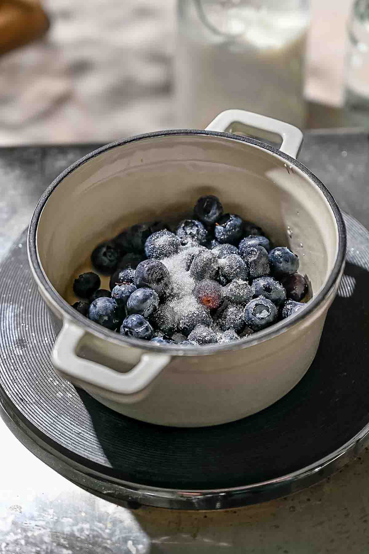fresh blueberries and sugar in a small pot.