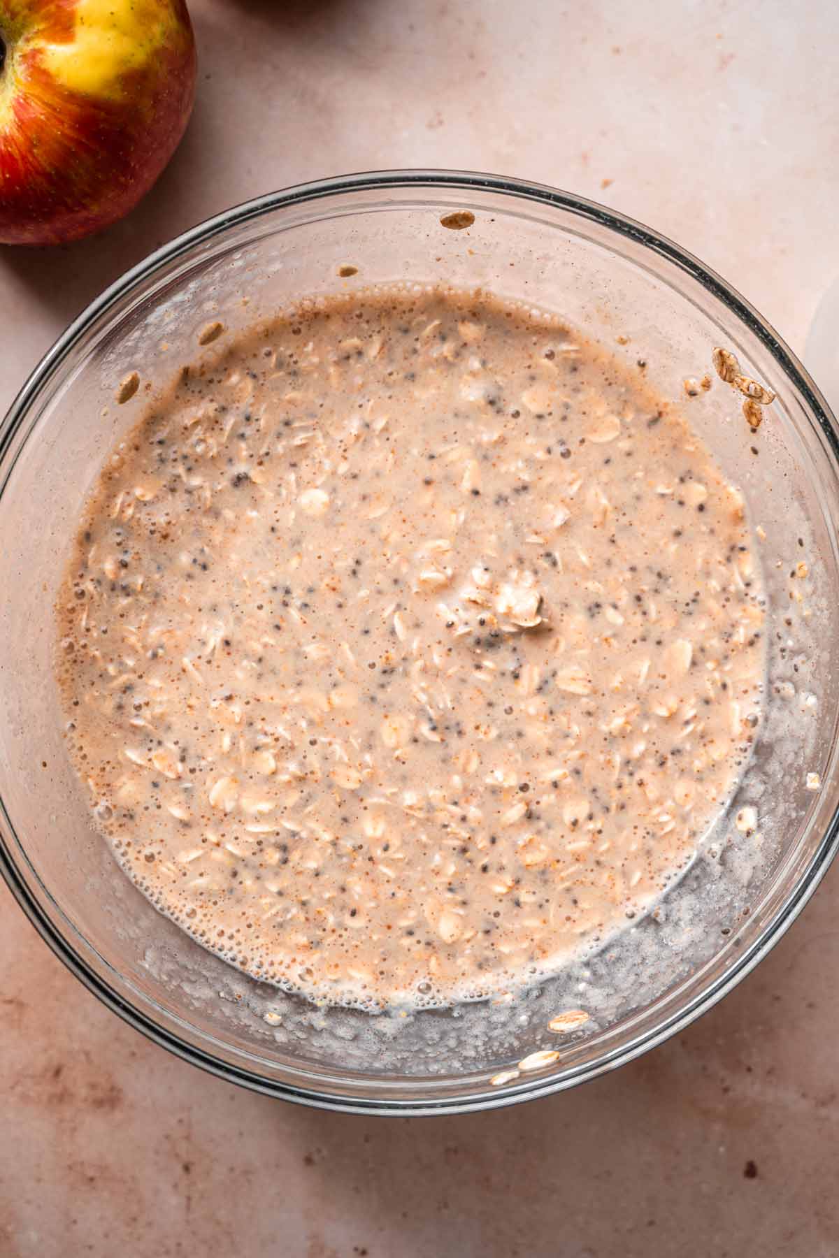 the mixed apple cinnamon overnight oats in a glass bowl.