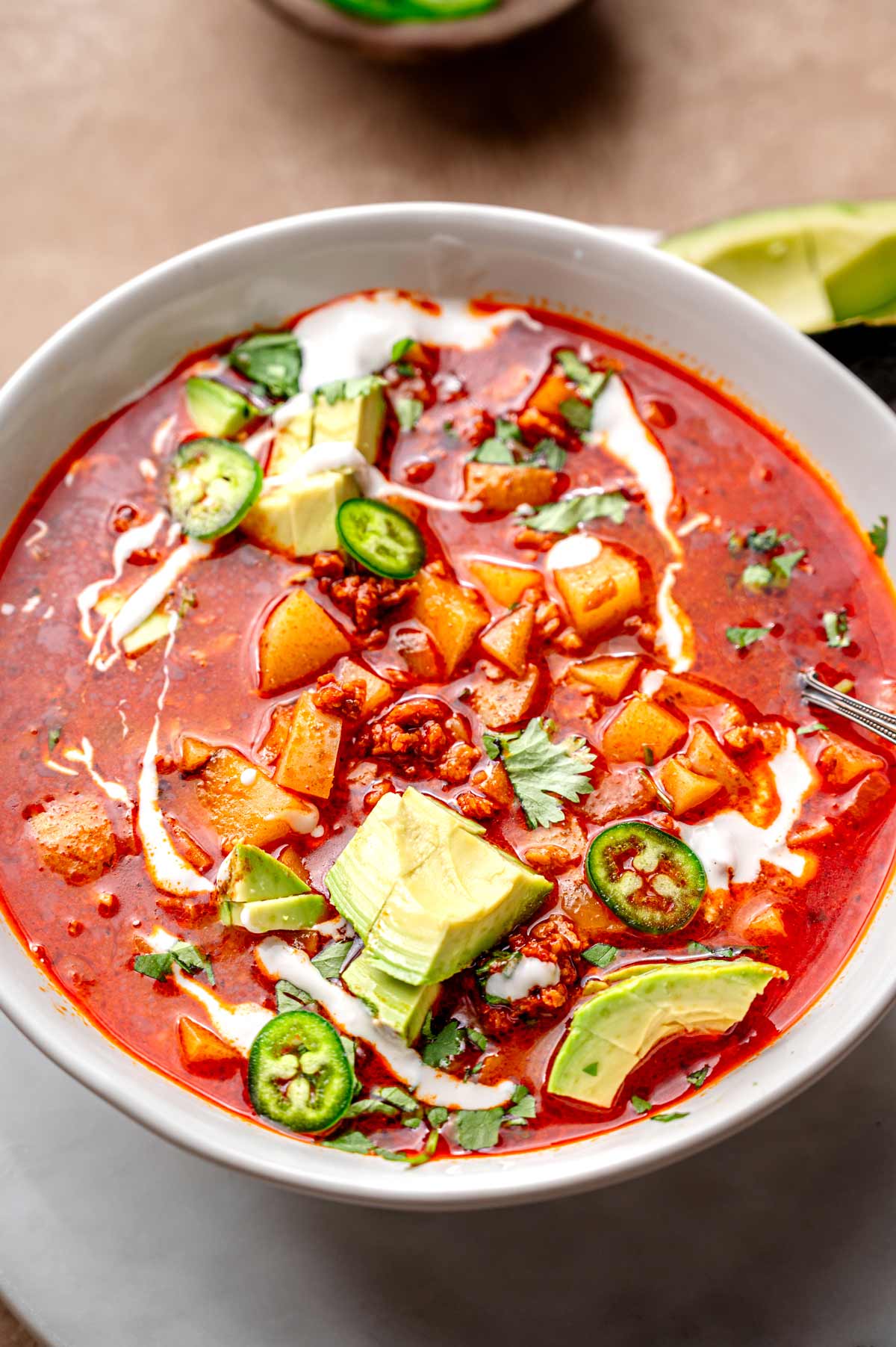 vegan chorizo stew with dairy free sour cream and avocado.