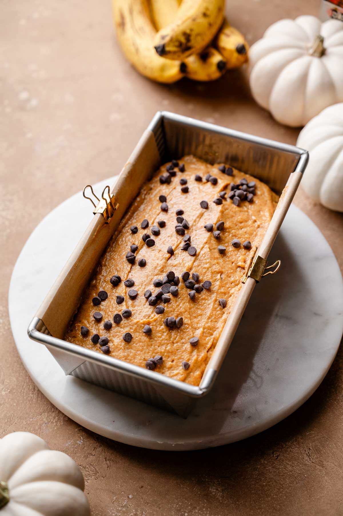the vegan pumpkin banana bread batter with chocolate chips on top.