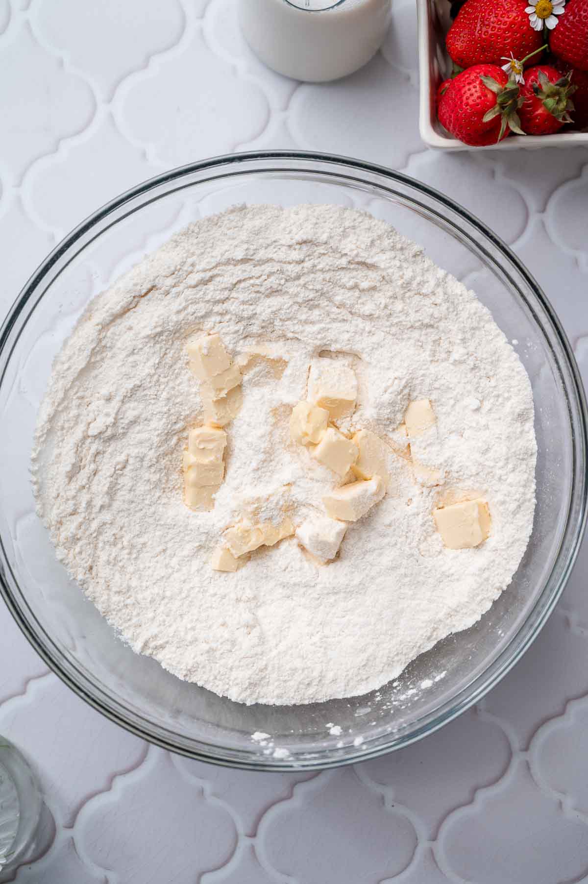 dry ingredients and vegan butter in a glass bowl.