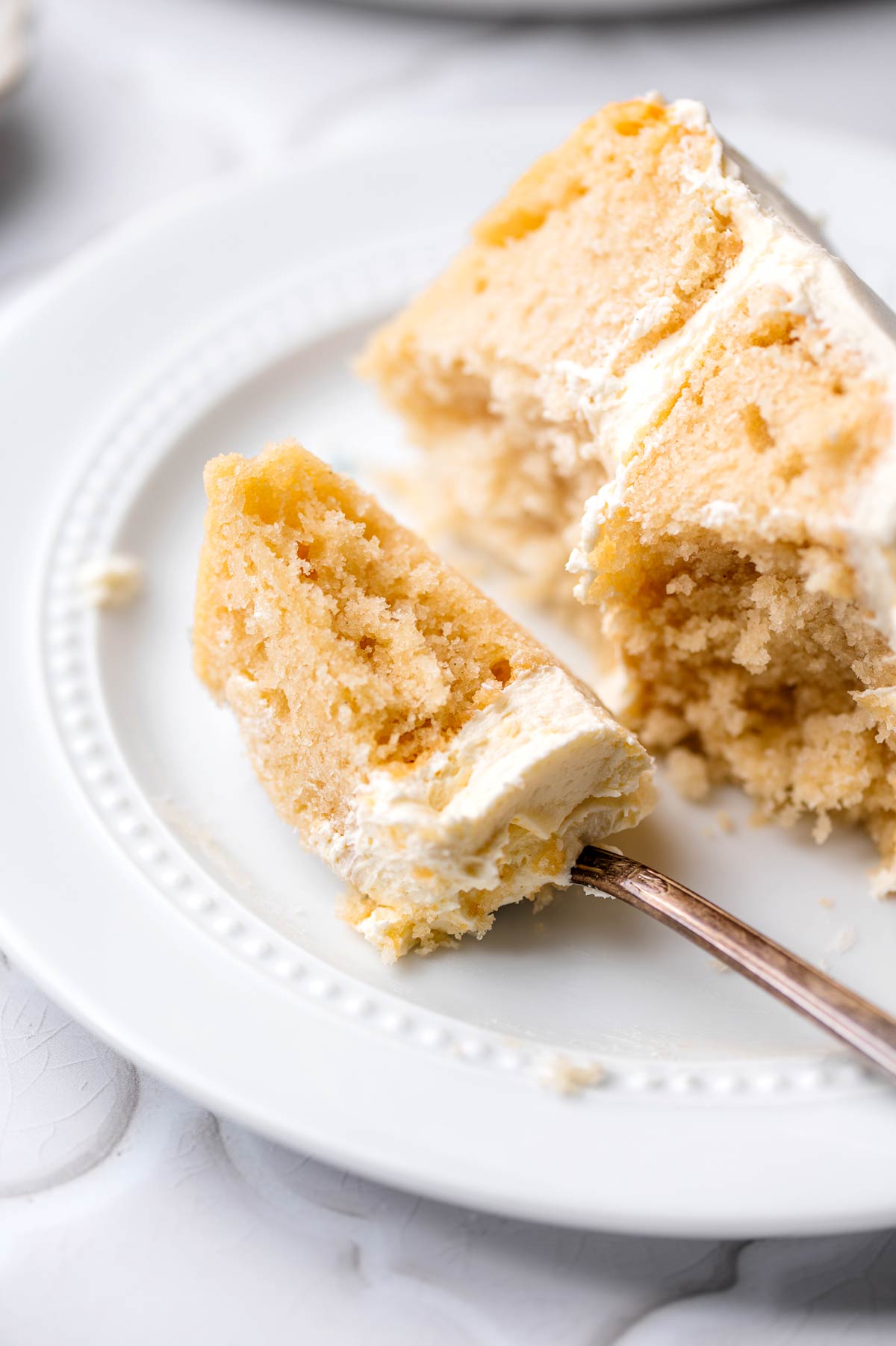 a piece of vegan vanilla cake on a fork.