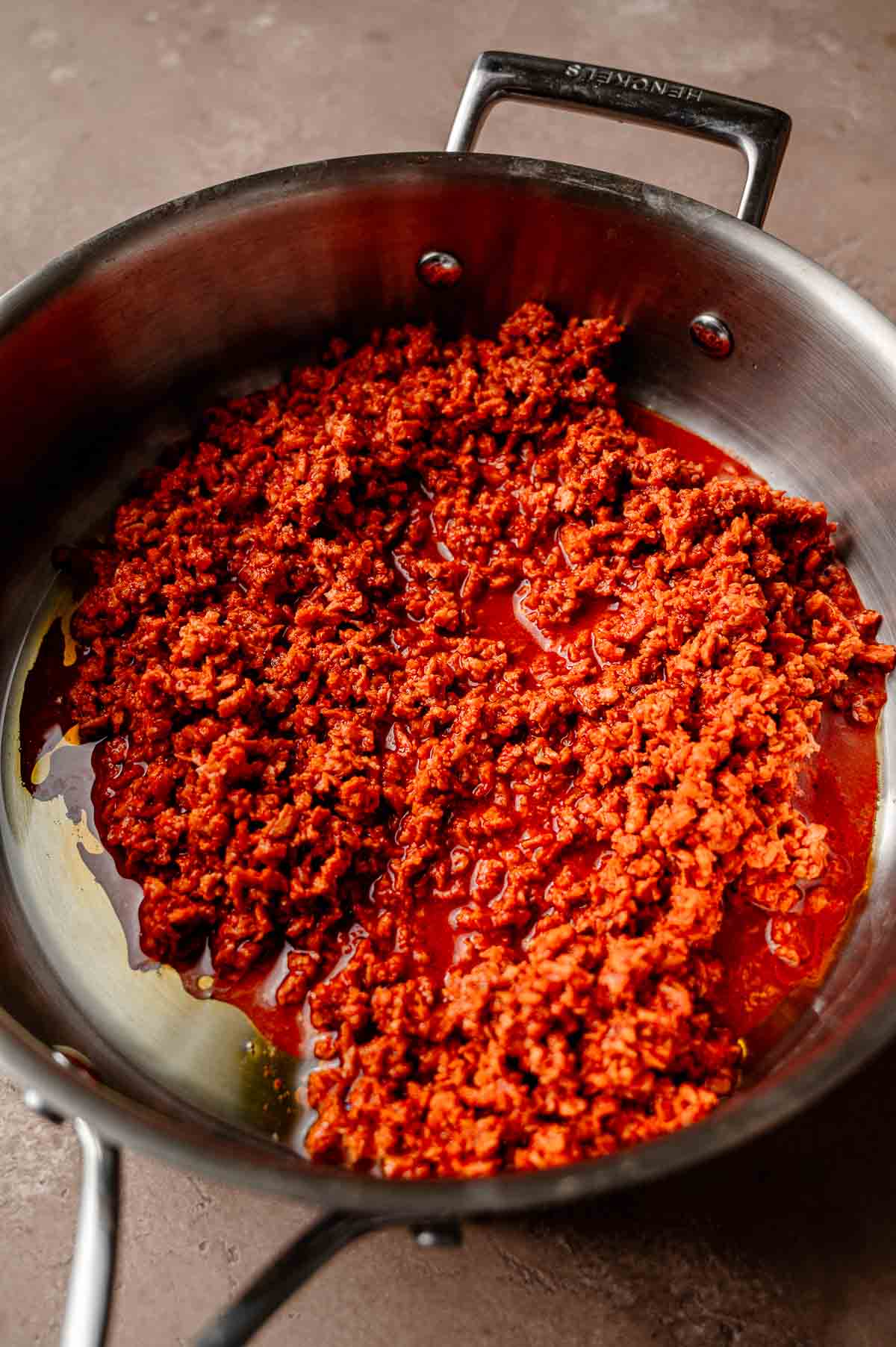 the soaked vegan chorizo in a stainless steel pan.