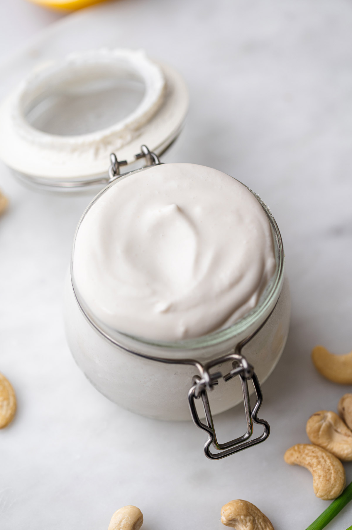 creamy vegan sour cream in a small glass jar.