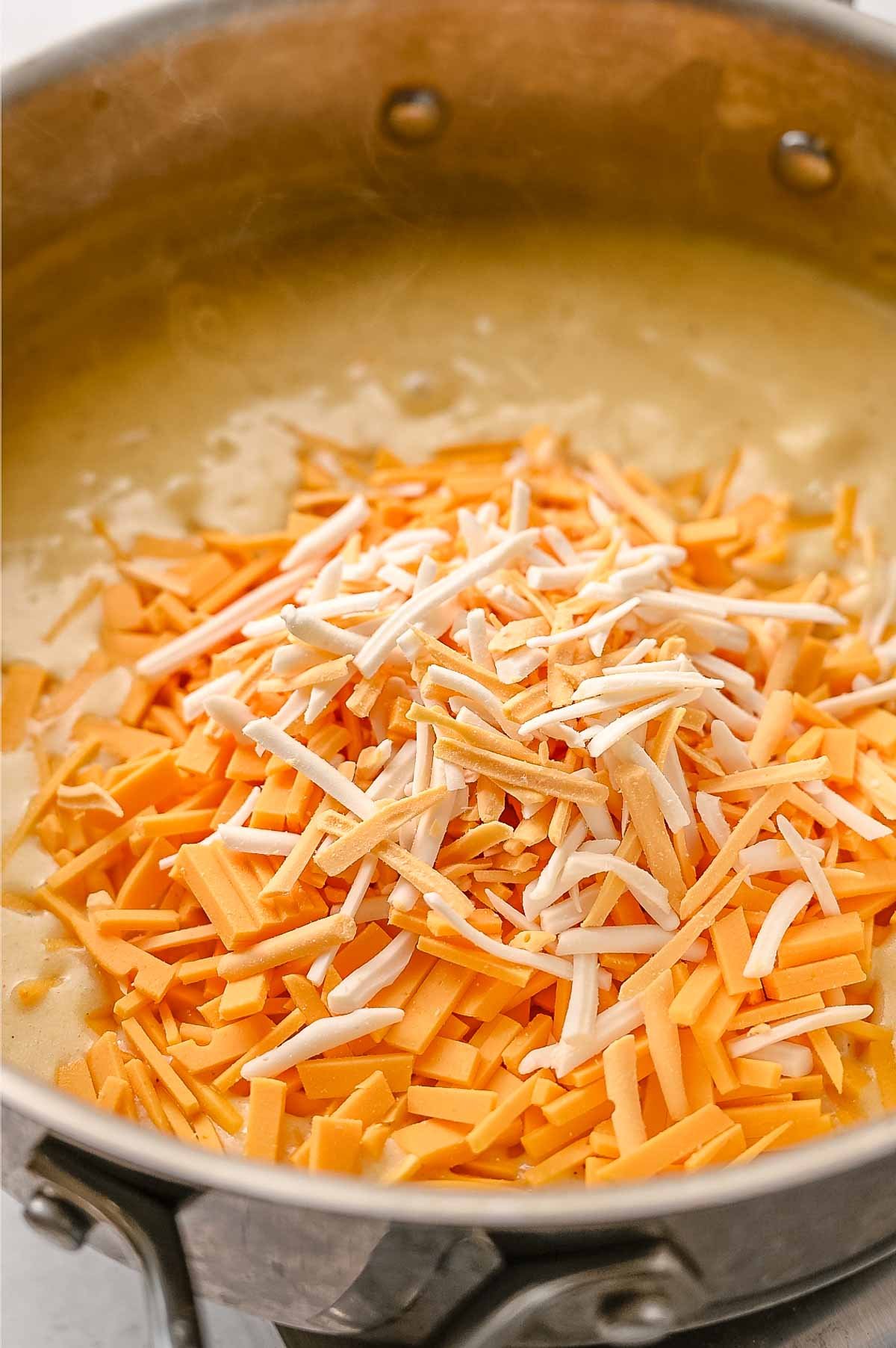 Vegan cheddar shreds added to the creamy base.