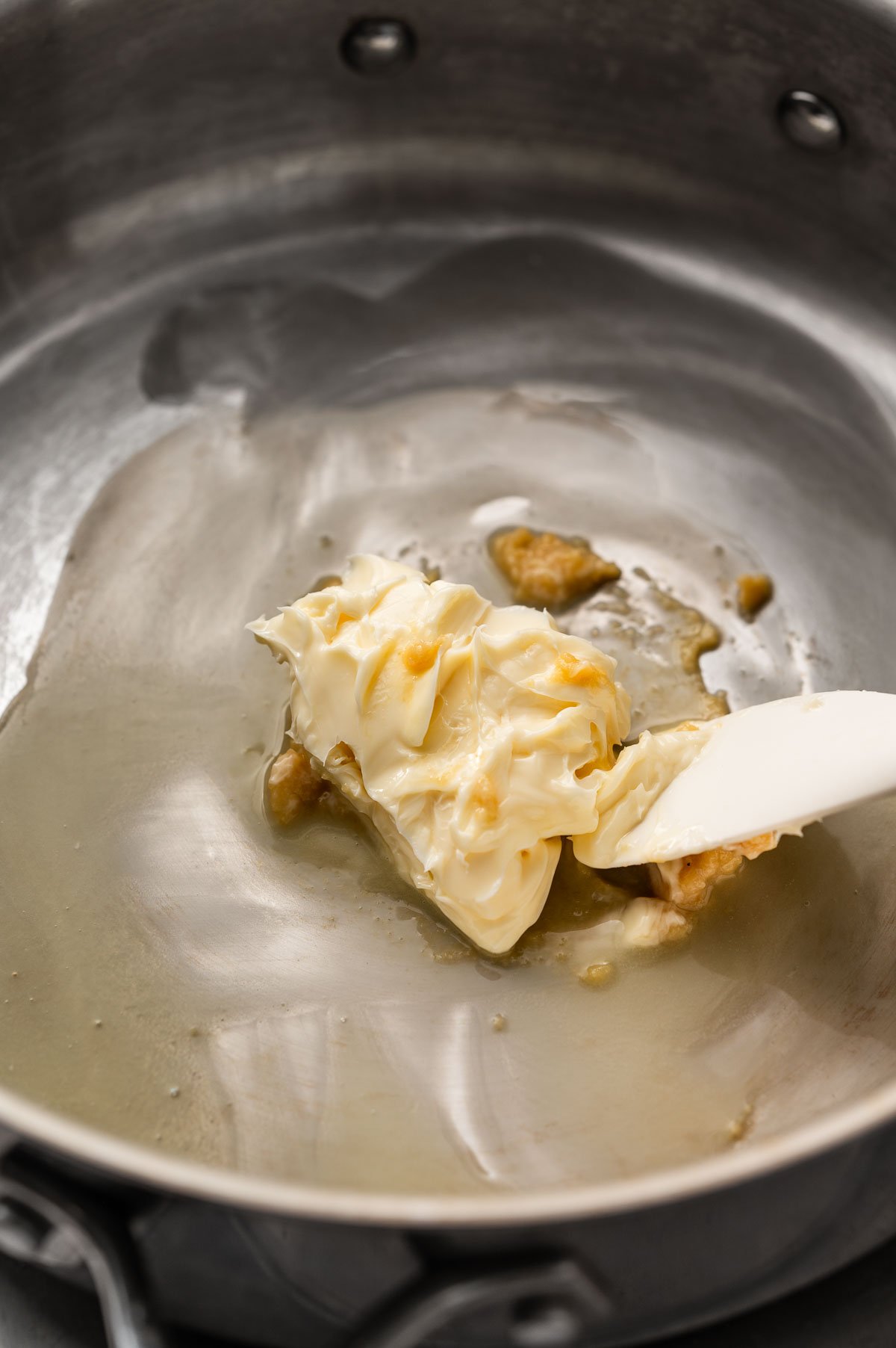 Miso and vegan butter melting in a saucepan.