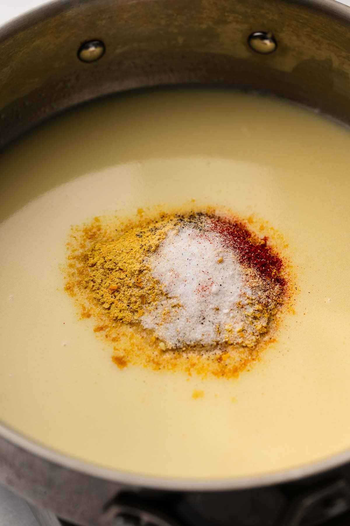 Soy milk with spices and nutritional yeast added to the pot.