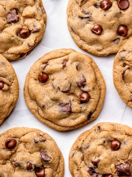Close-up of freshly baked vegan chocolate chip cookies showing gooey melted chocolate and soft, chewy texture.