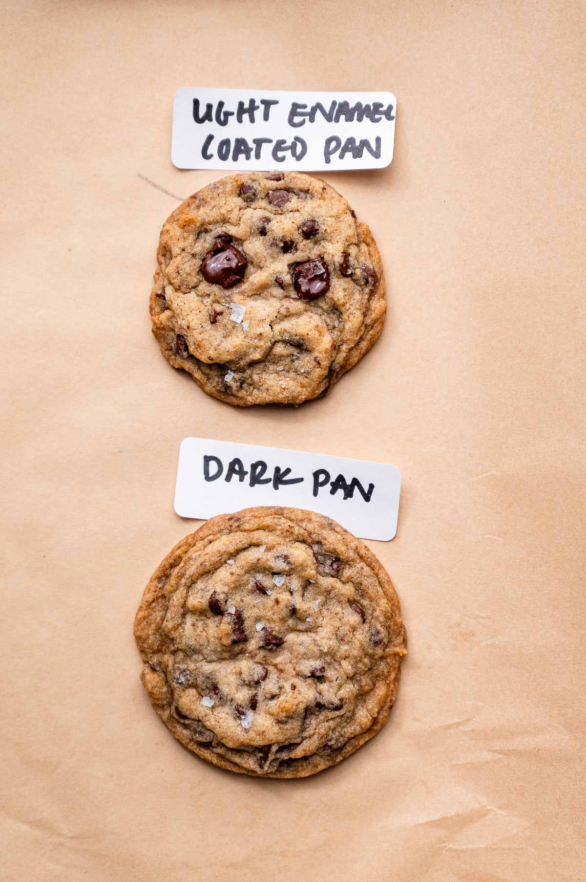 two cookies on a baking sheet with a label of what type of pan it was baked on.