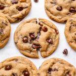 Soft and chewy vegan chocolate chip cookies with melted chocolate chips, arranged on a round plate.