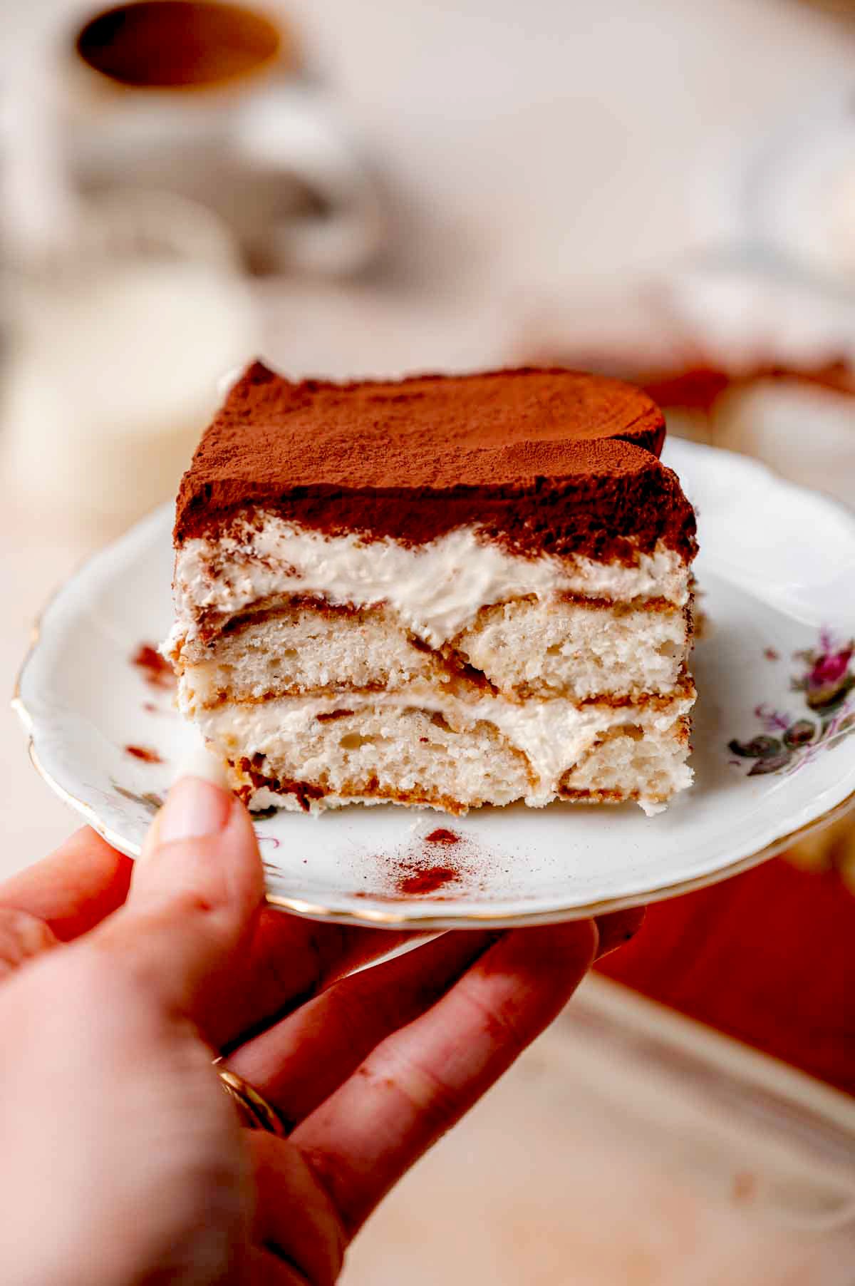 a slice of vegan tiramisu on a small vintage dessert plate.