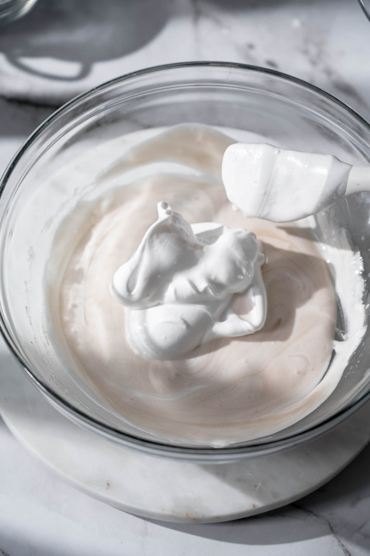 Folding whipped aquafaba into the batter to create a light vegan sponge for ladyfingers.