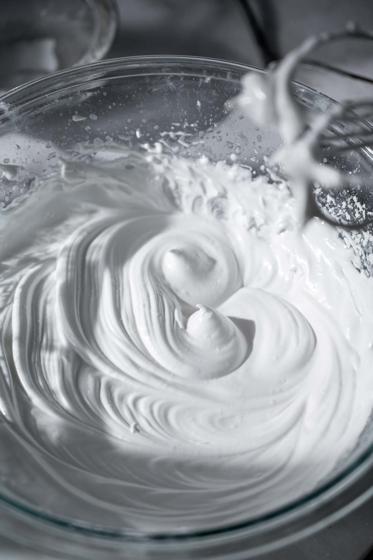 Stiff, glossy whipped aquafaba with soft peaks for eggless ladyfinger cookies.