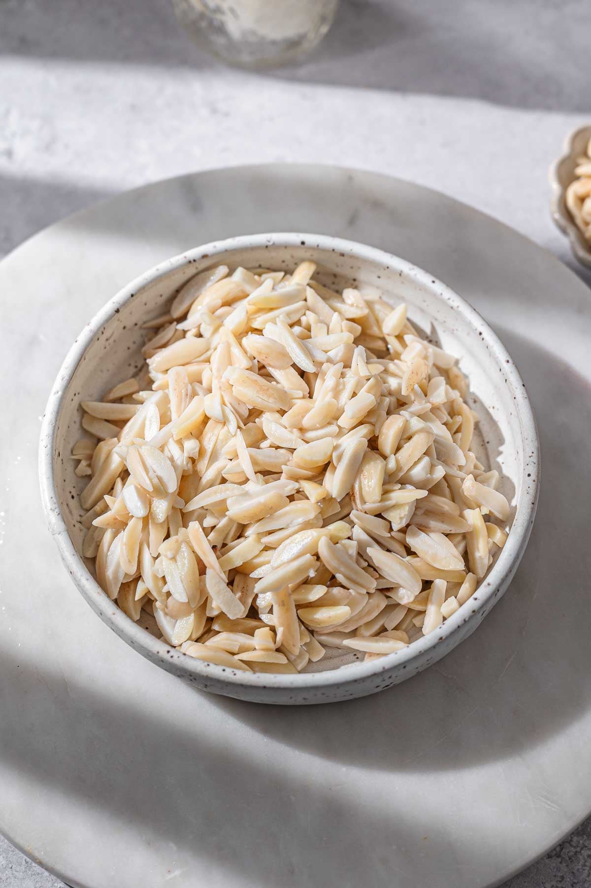soaked blanched almonds in a small bowl.