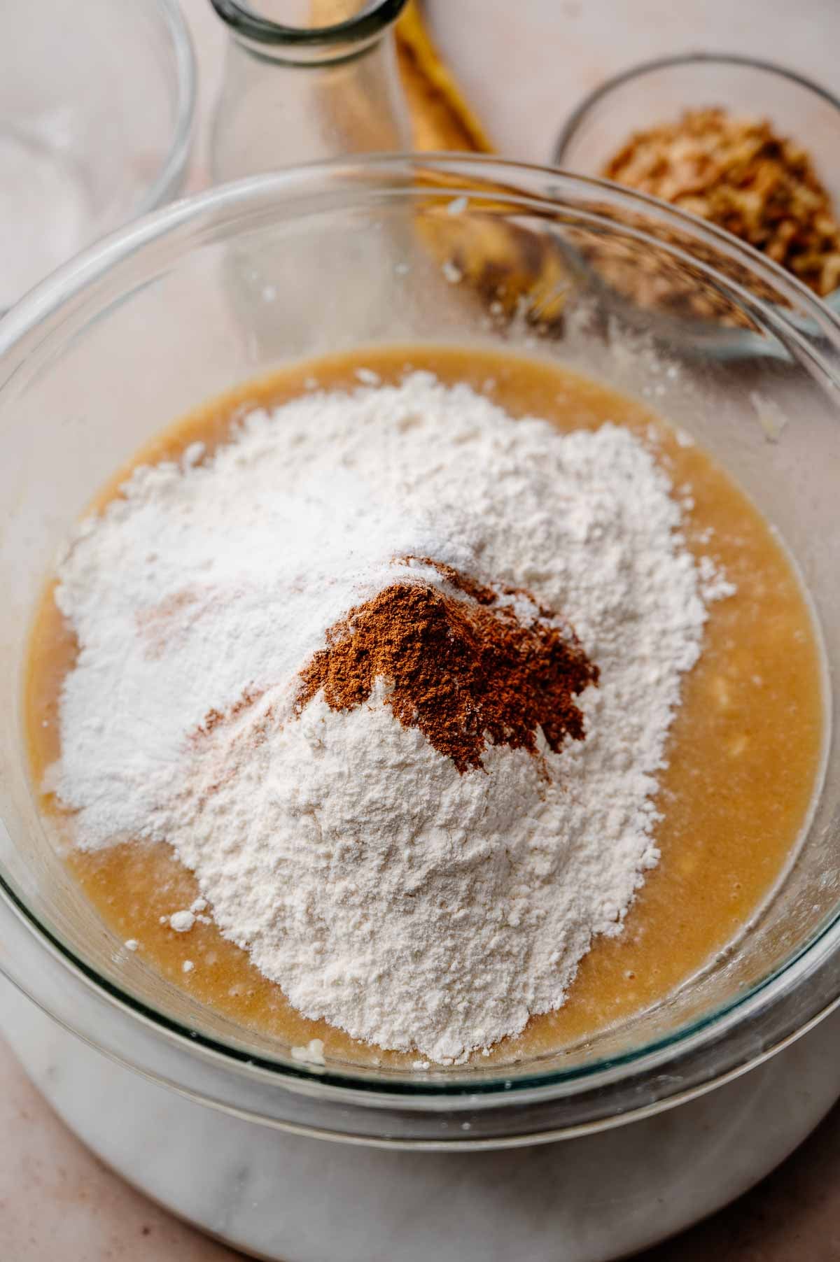 dry ingredients on the mixed wet ingredients for dairy-free banana bread.