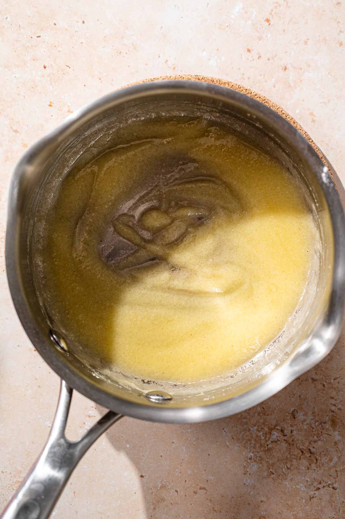 a roux made with vegan butter and tapioca starch in a small stainless steel pot.