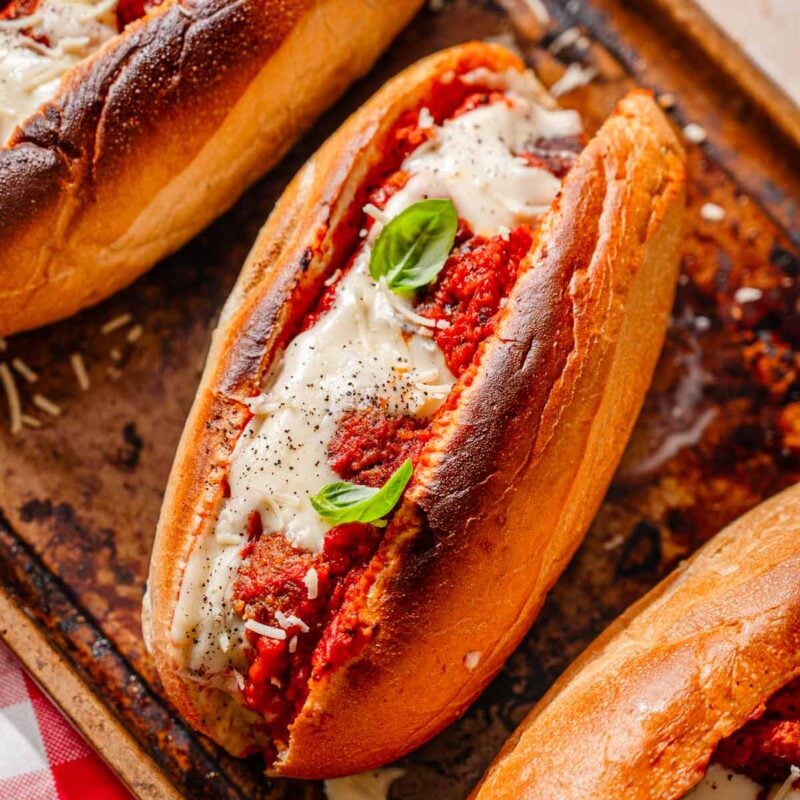a toasted vegan meatball sub stuffed with homemade tvp meatballs and topped with a dairy-free cheese.