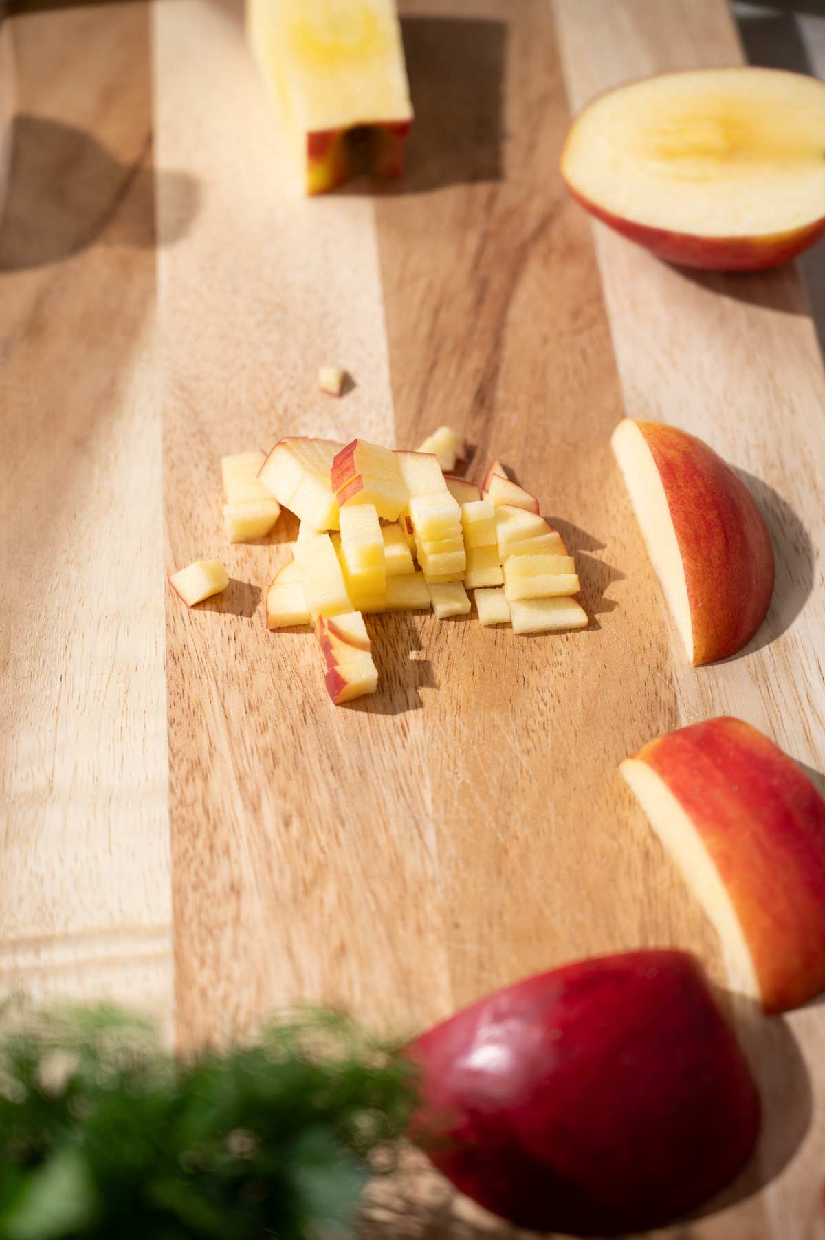 diced apples on a wooden cutting board.