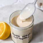 a jar of vegan buttermilk with a spoon dipping in it.