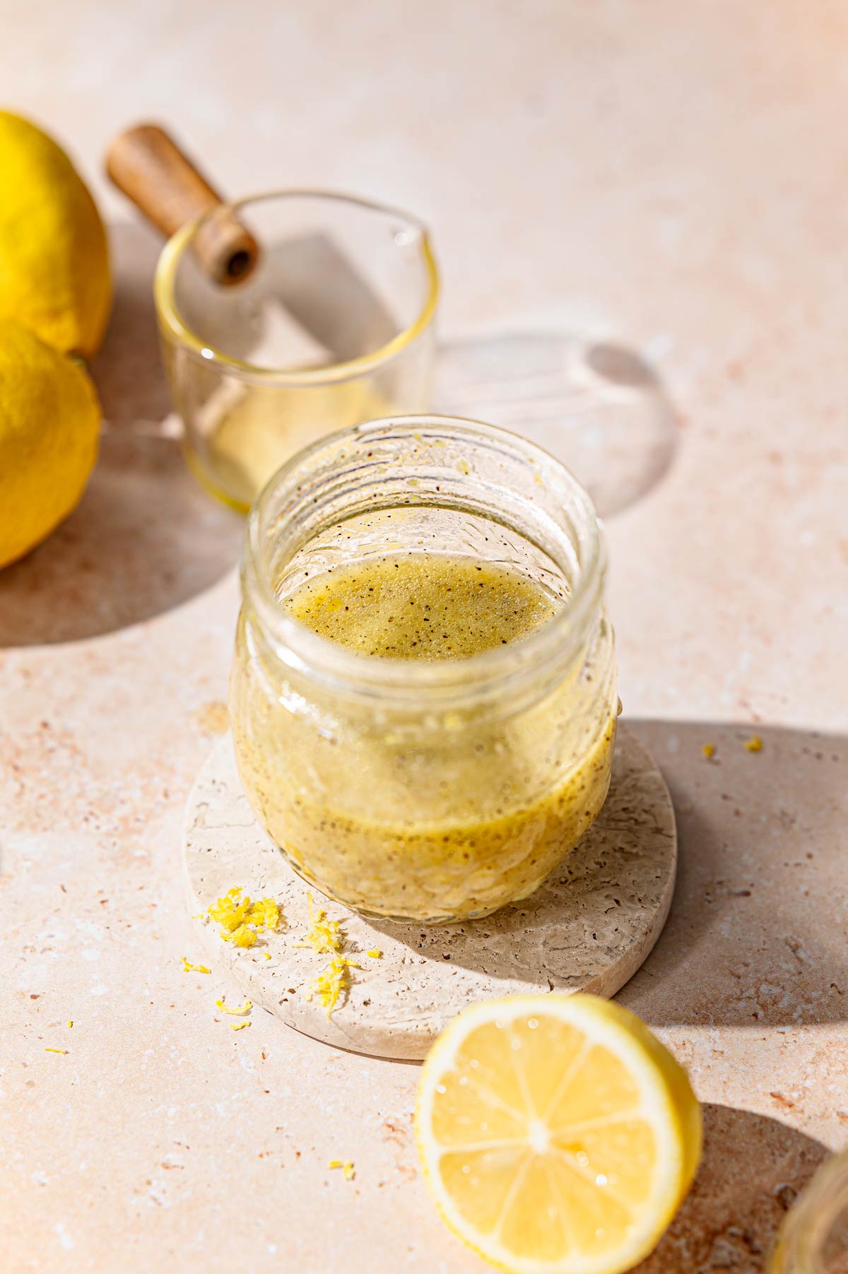 all the lemon dressing ingredients in a glass jar mixed together.