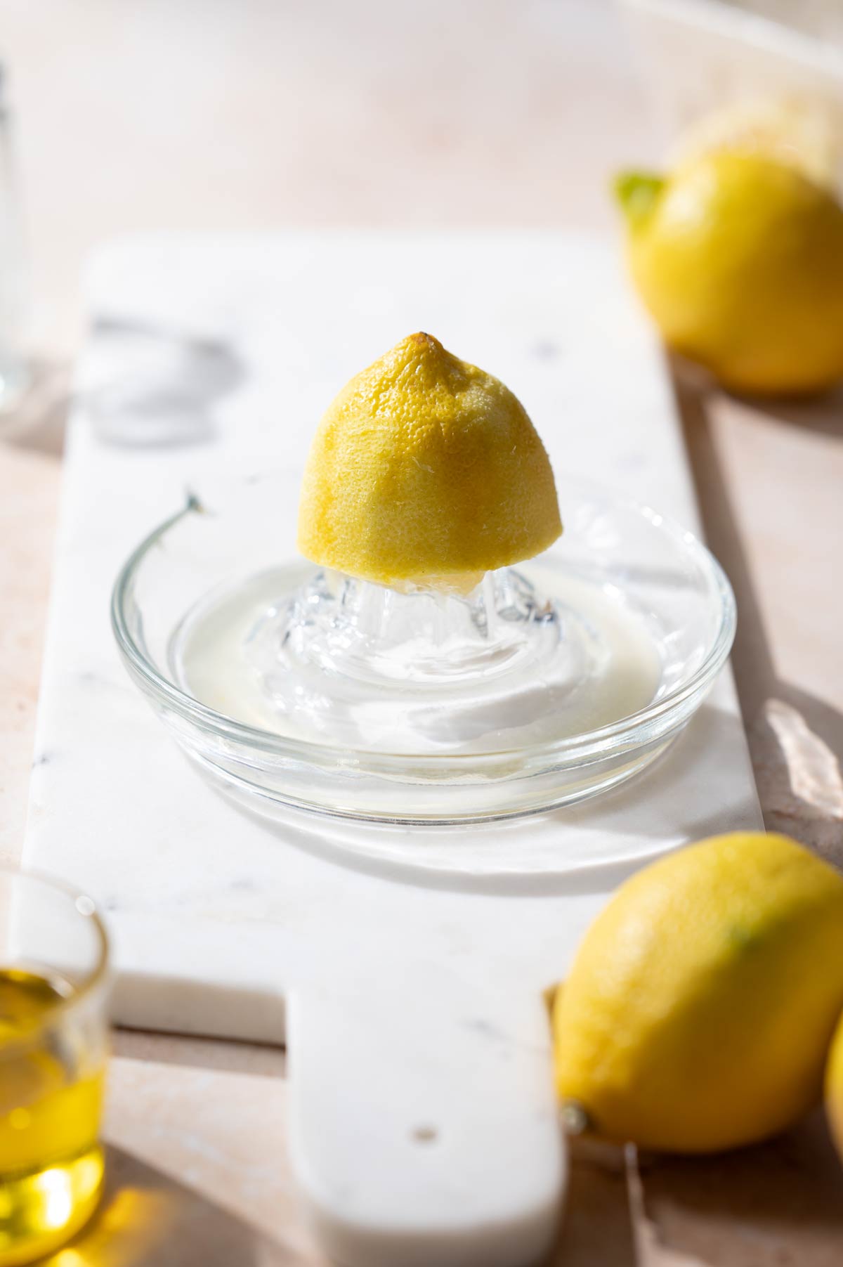half a lemon on a glass juicer.