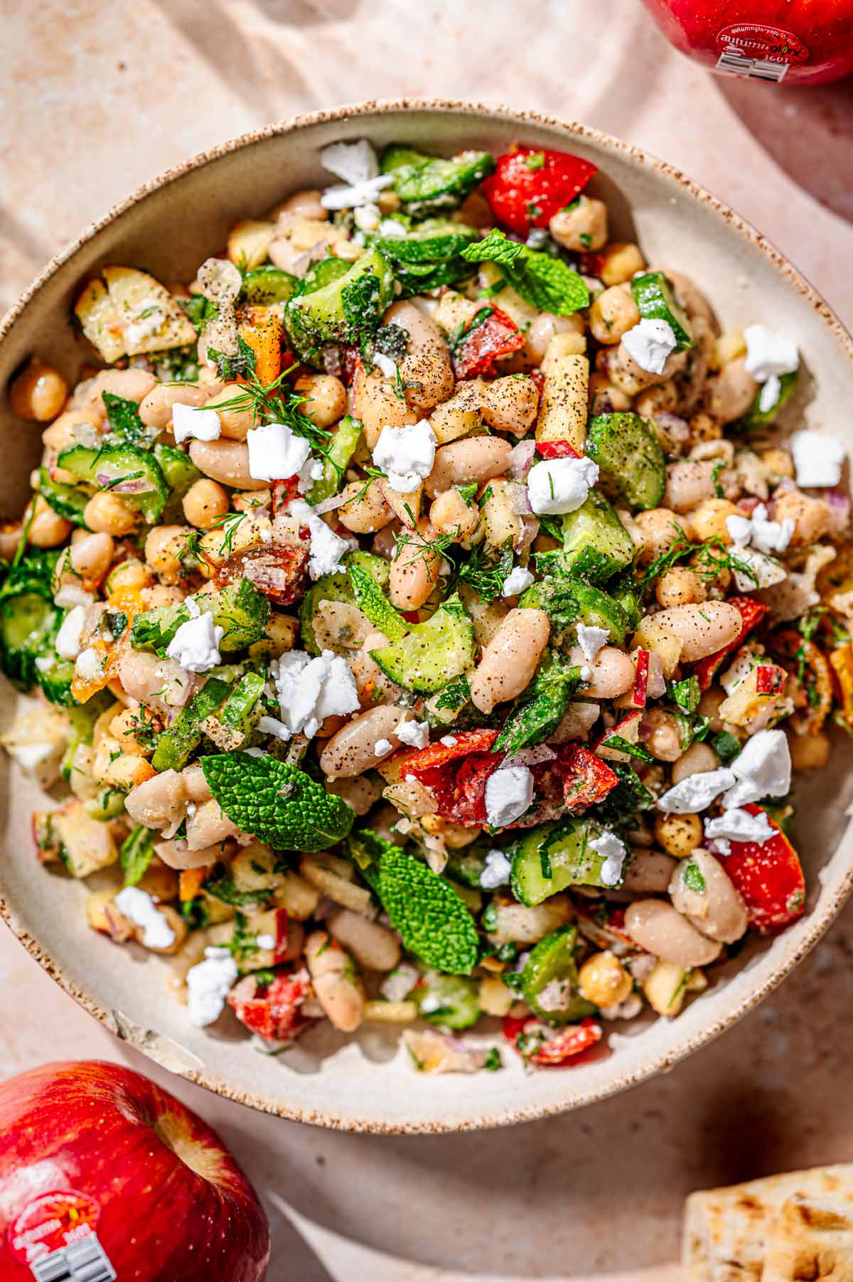 vegan dense bean salad with white beans, chickpeas, vegan feta and more.
