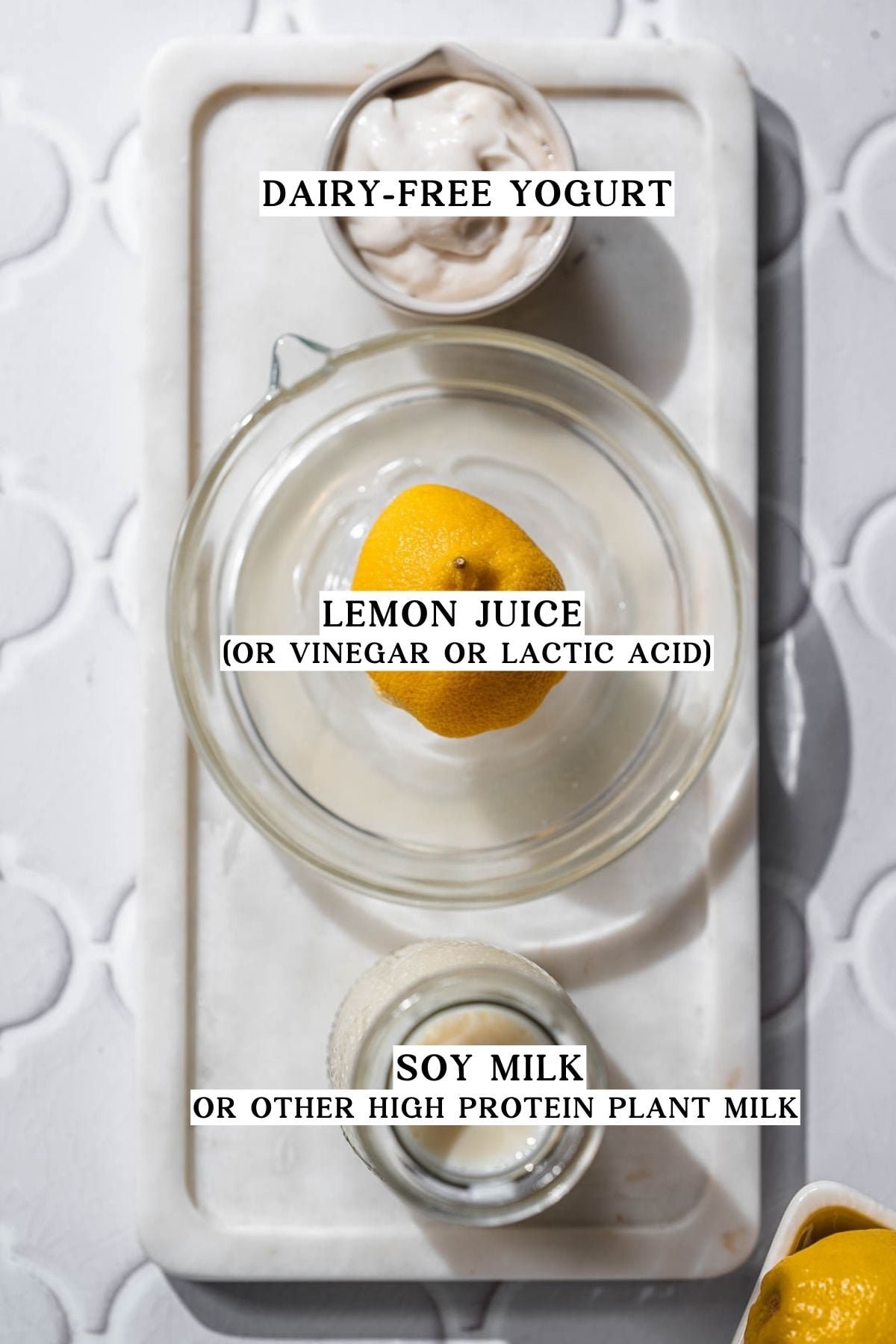 dairy free yogurt, lemon juice and soy milk on a marble tray.