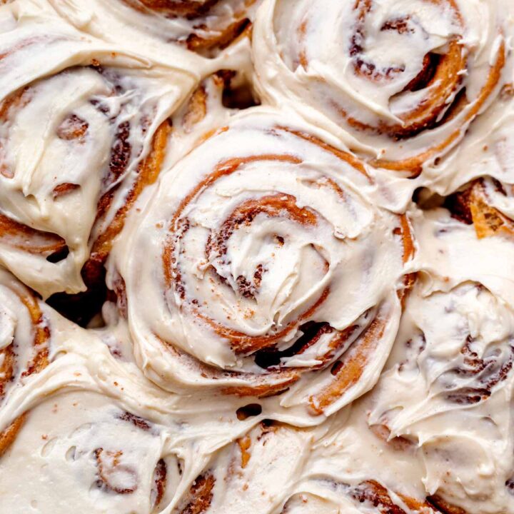 a top view of the baked vegan cinnamon rolls topped with a cream cheese frosting.