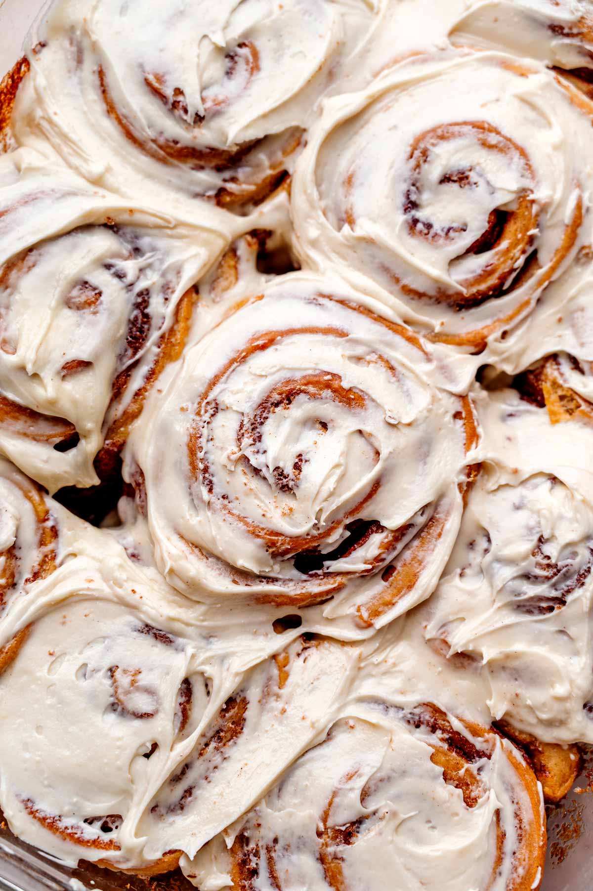 a top view of the baked vegan cinnamon rolls topped with a cream cheese frosting.