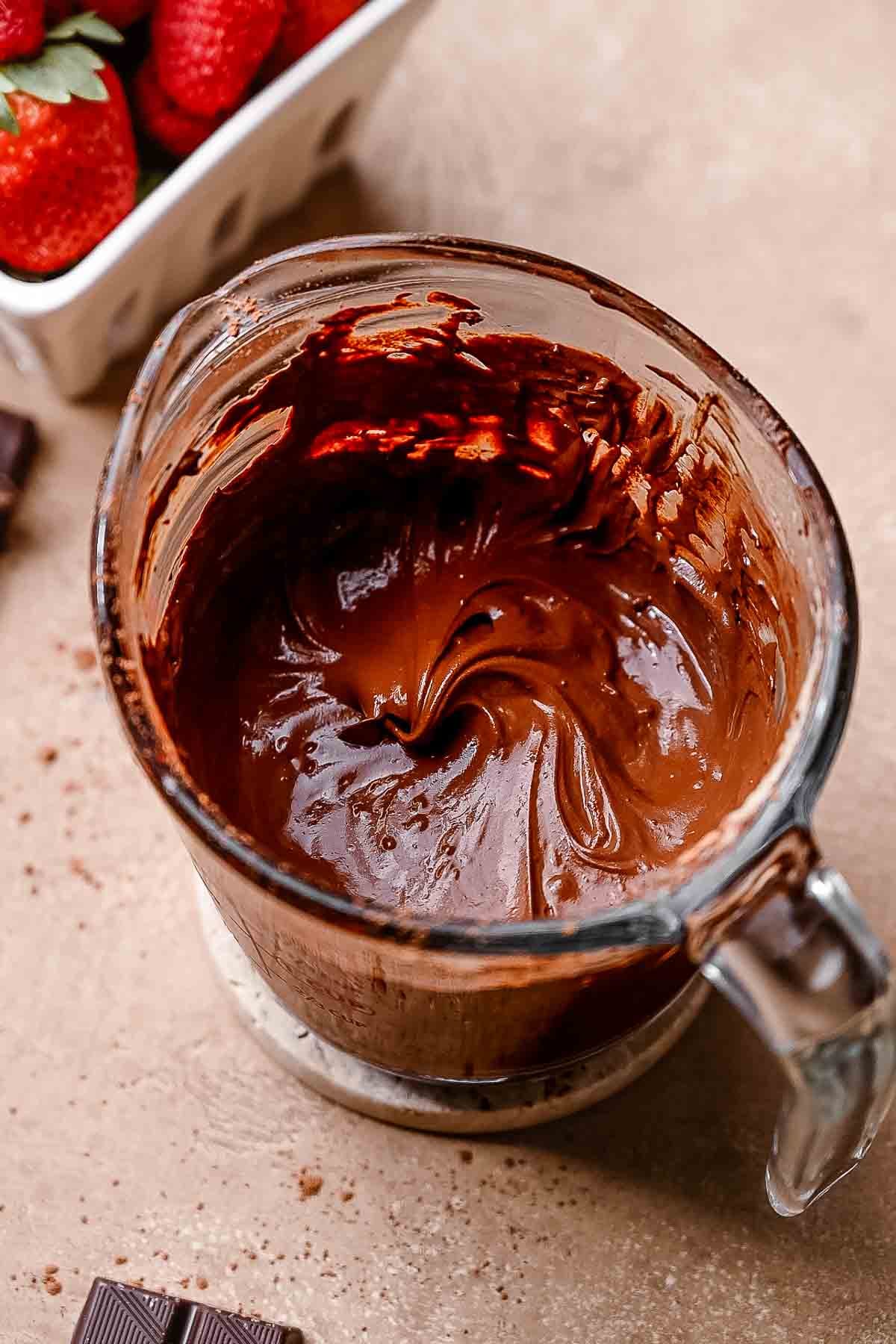 the bloomed cocoa powder in a glass measuring cup.