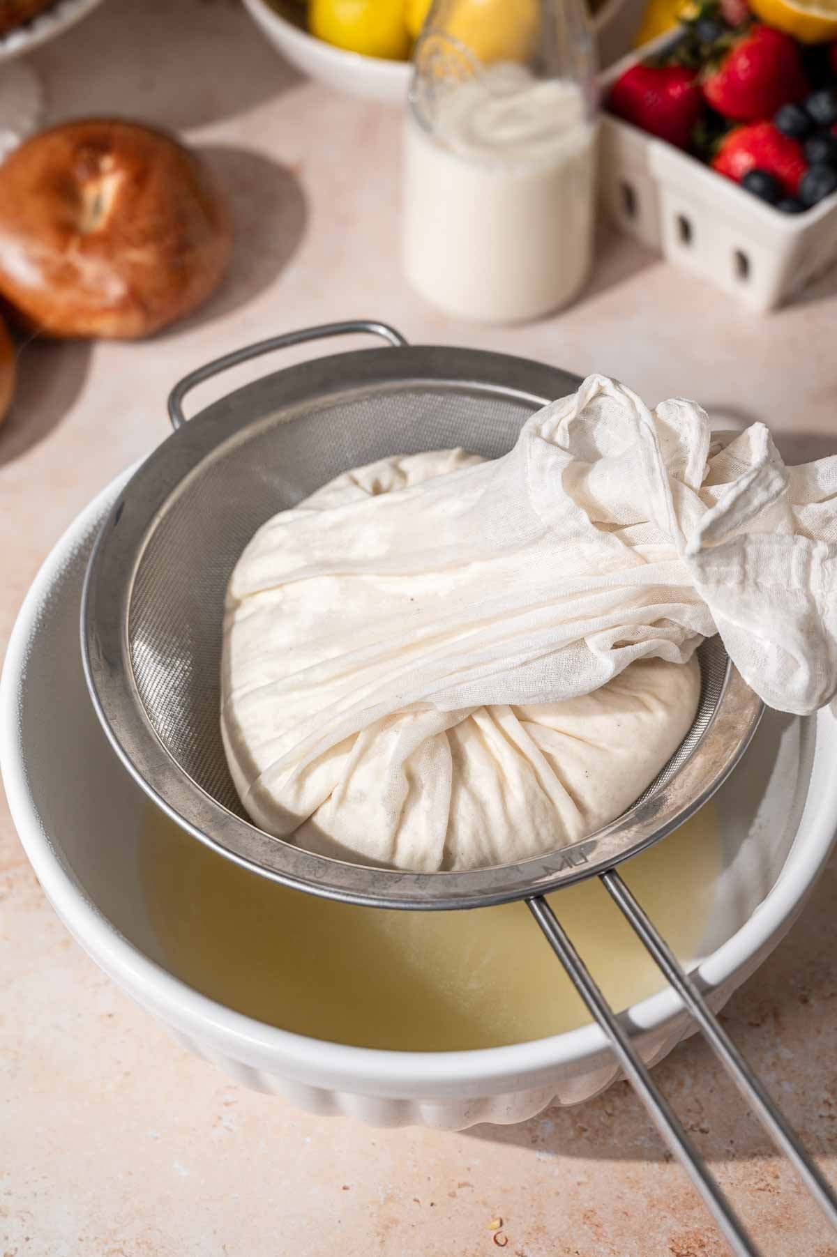 the yellow soy whey draining away from the curds in the cheesecloth.
