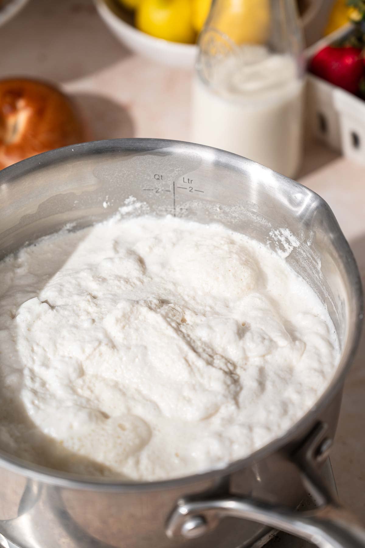 the soy milk mixture simmering and forming curds.