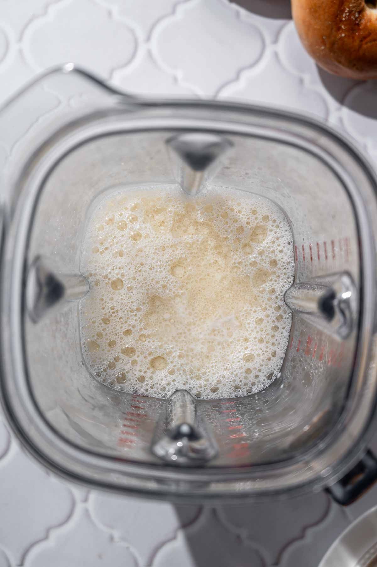 soy milk and melted coconut oil in a large blender.