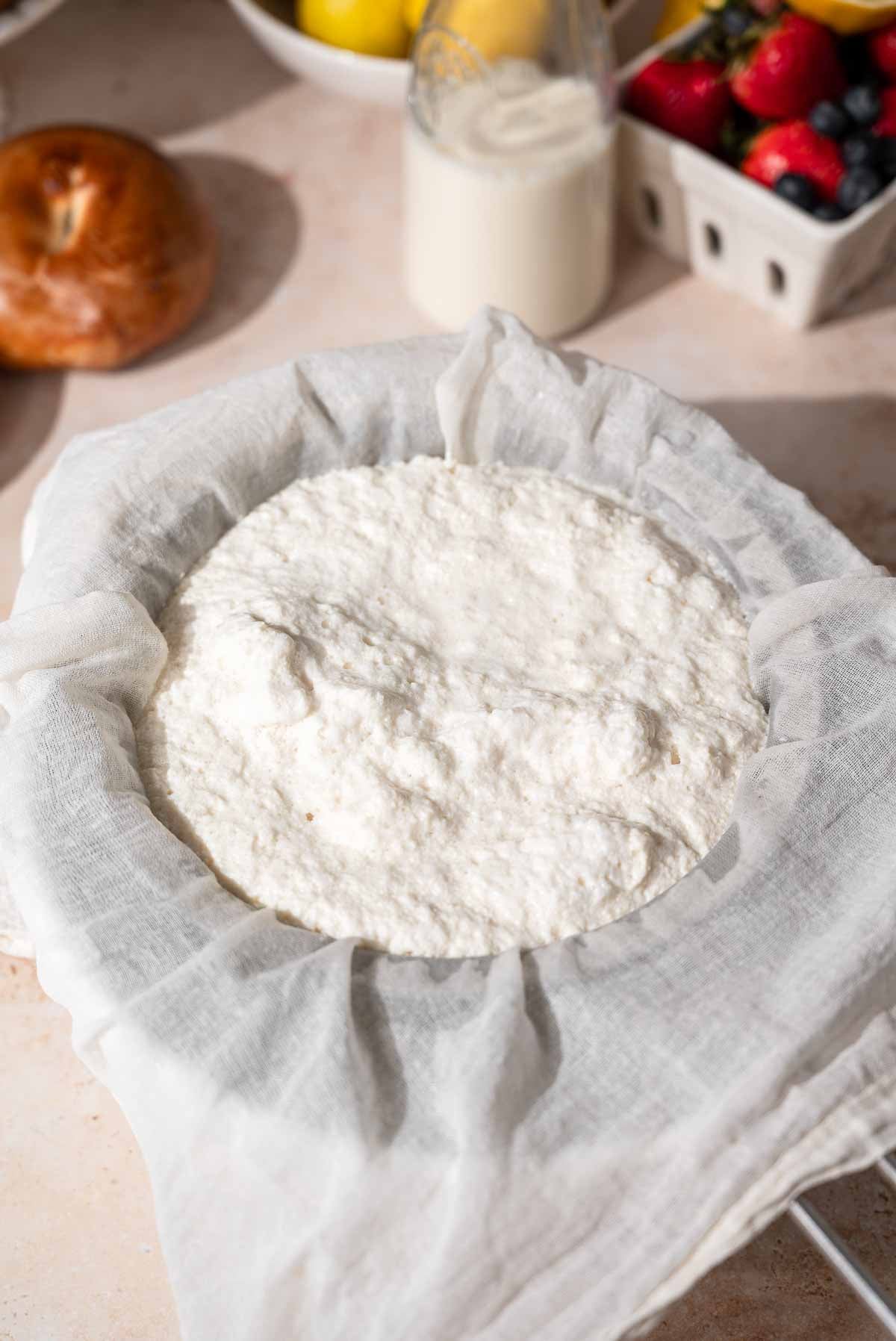 the curds straining over a bowl.