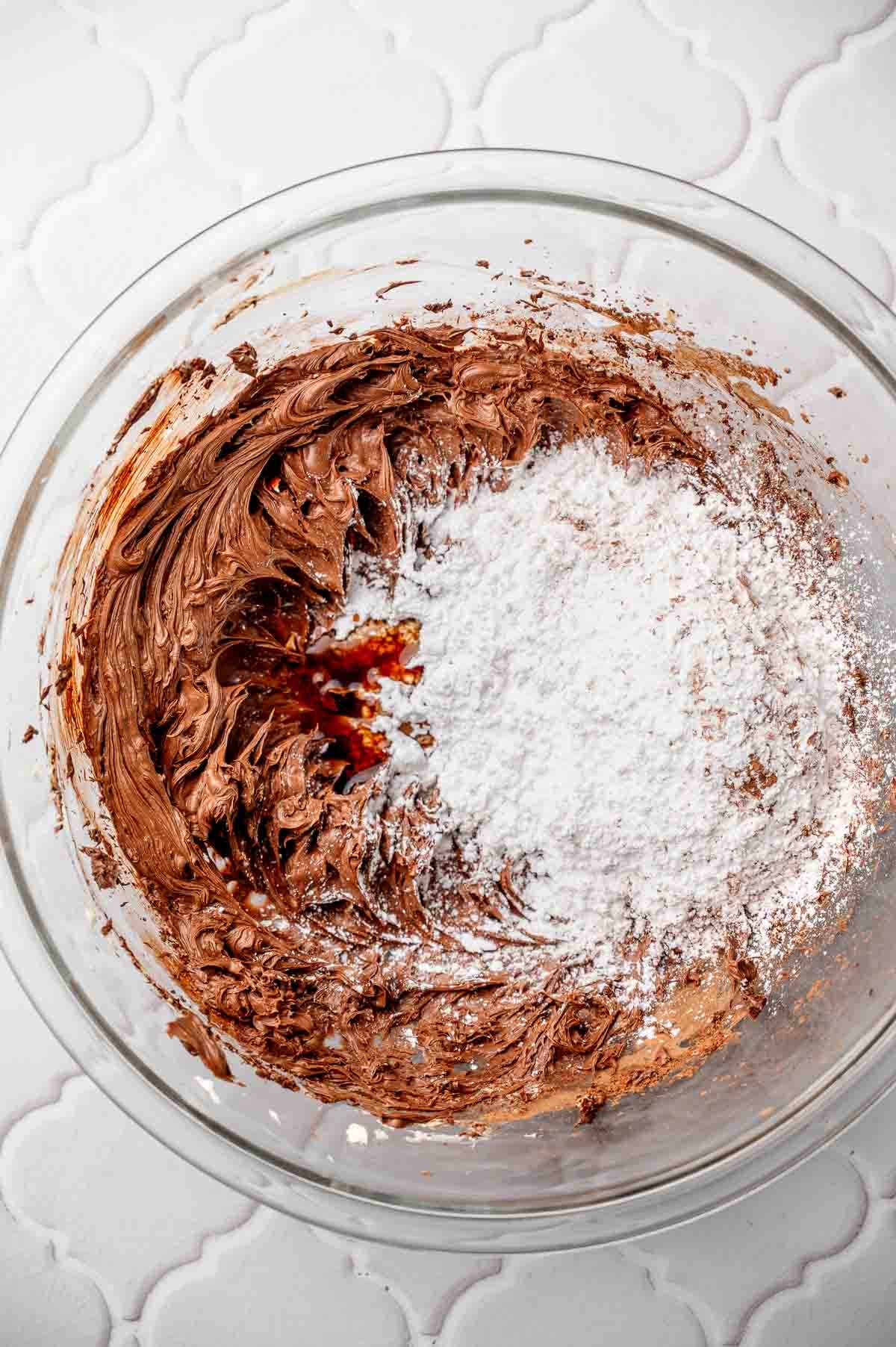 beaten vegan chocolate frosting with powdered sugar on top.