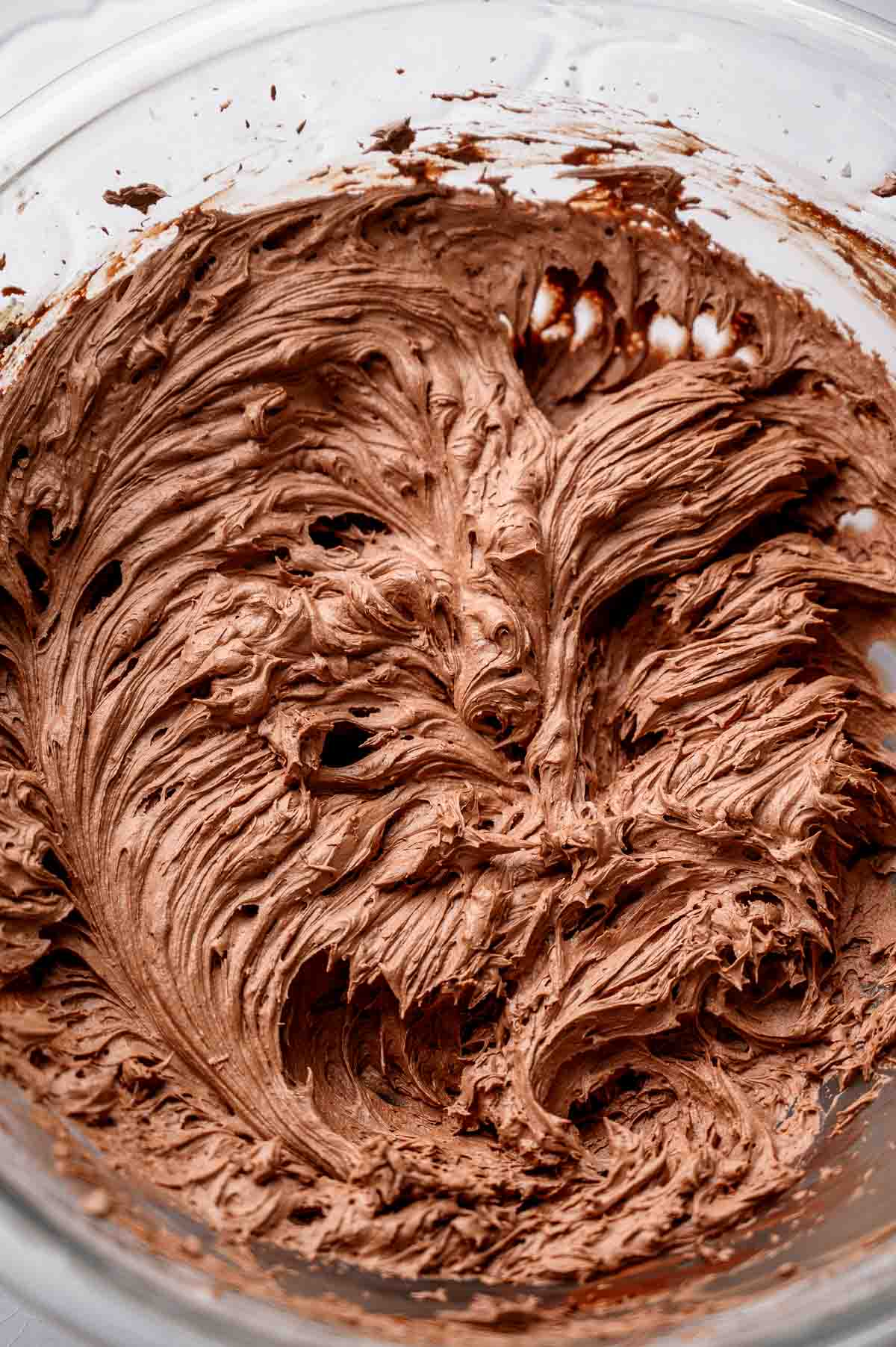 creamed vegan chocolate buttercream in a large glass bowl.