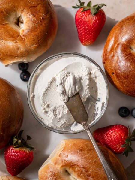 the thickened vegan cream cheese in a small glass container.