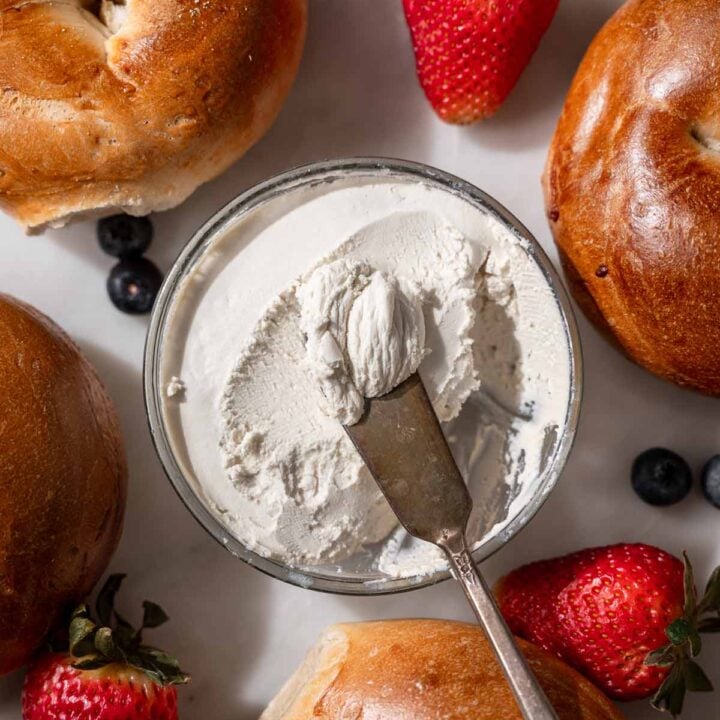 the thickened vegan cream cheese in a small glass container.
