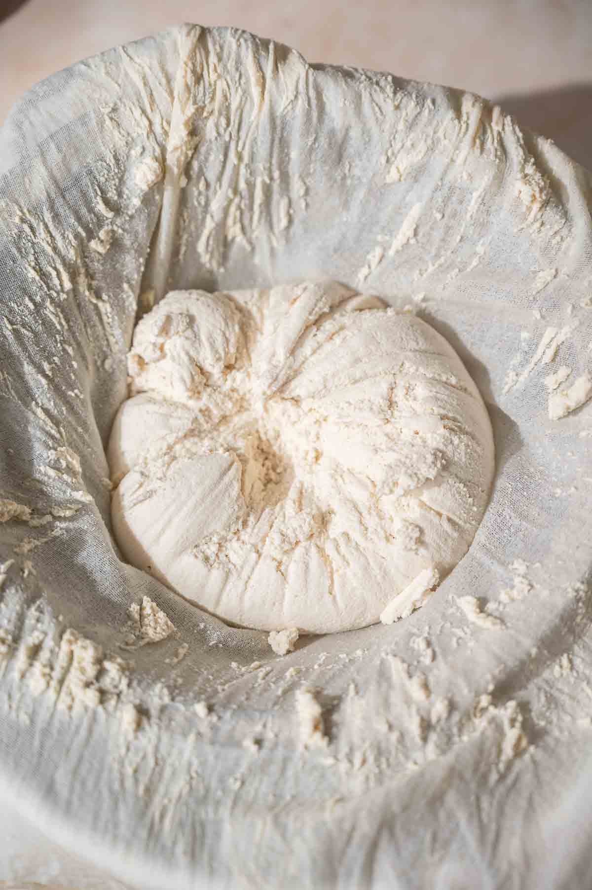 the strained soy cheese curds in a cheesecloth.
