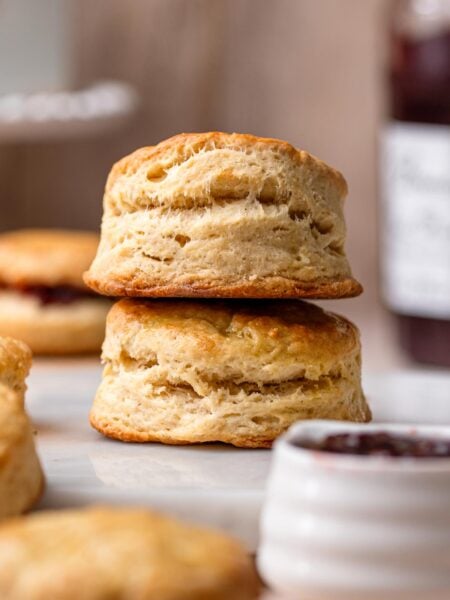 two vegan buttermilk biscuits stacked on top of each other.