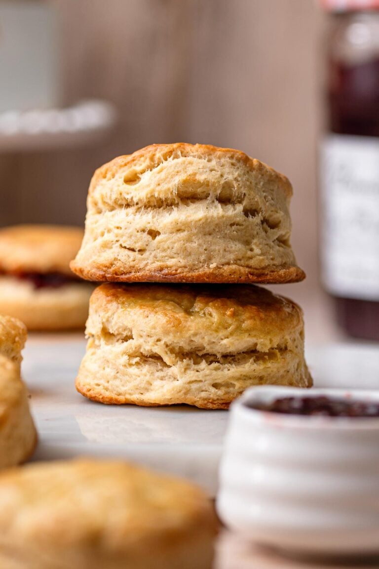 two vegan buttermilk biscuits stacked on top of each other.