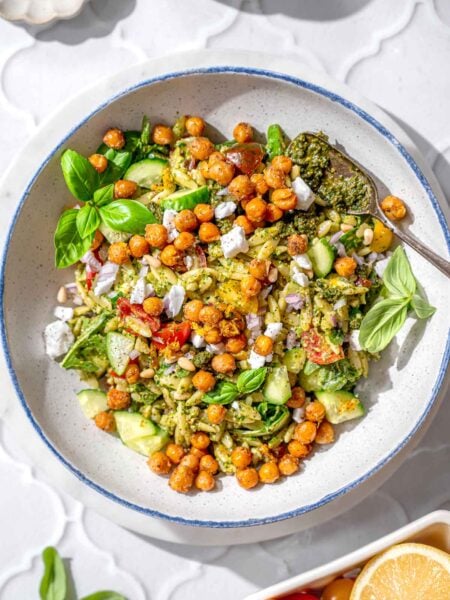 pesto orzo salad topped with roasted lemon chickpeas.