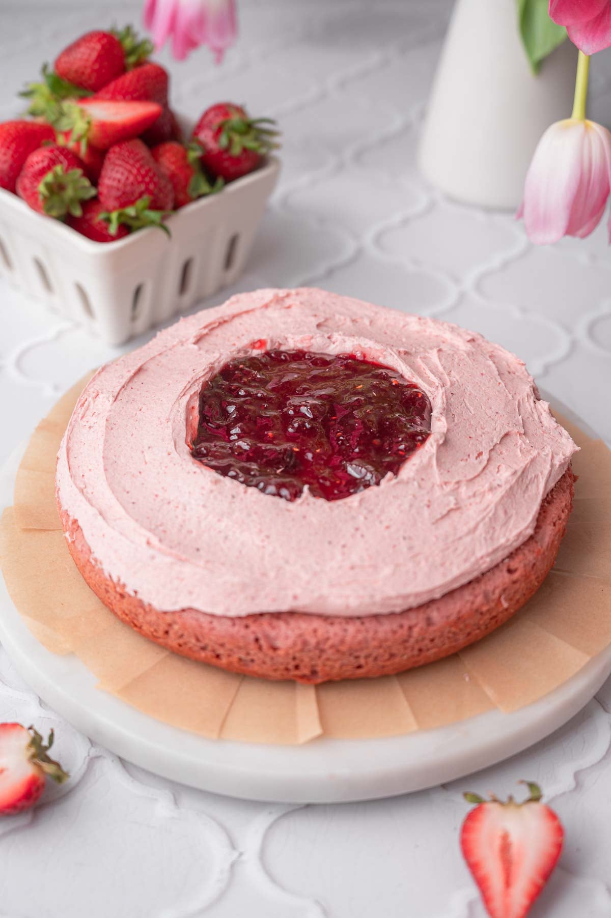 the layer cake with strawberry frosting and jam.