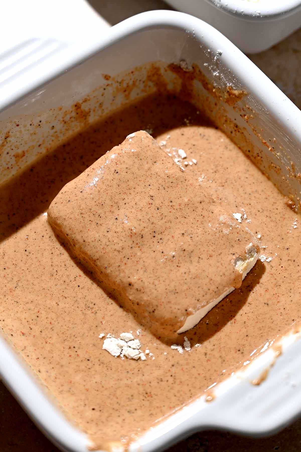 a slab of tofu in a spiced cornstarch batter.