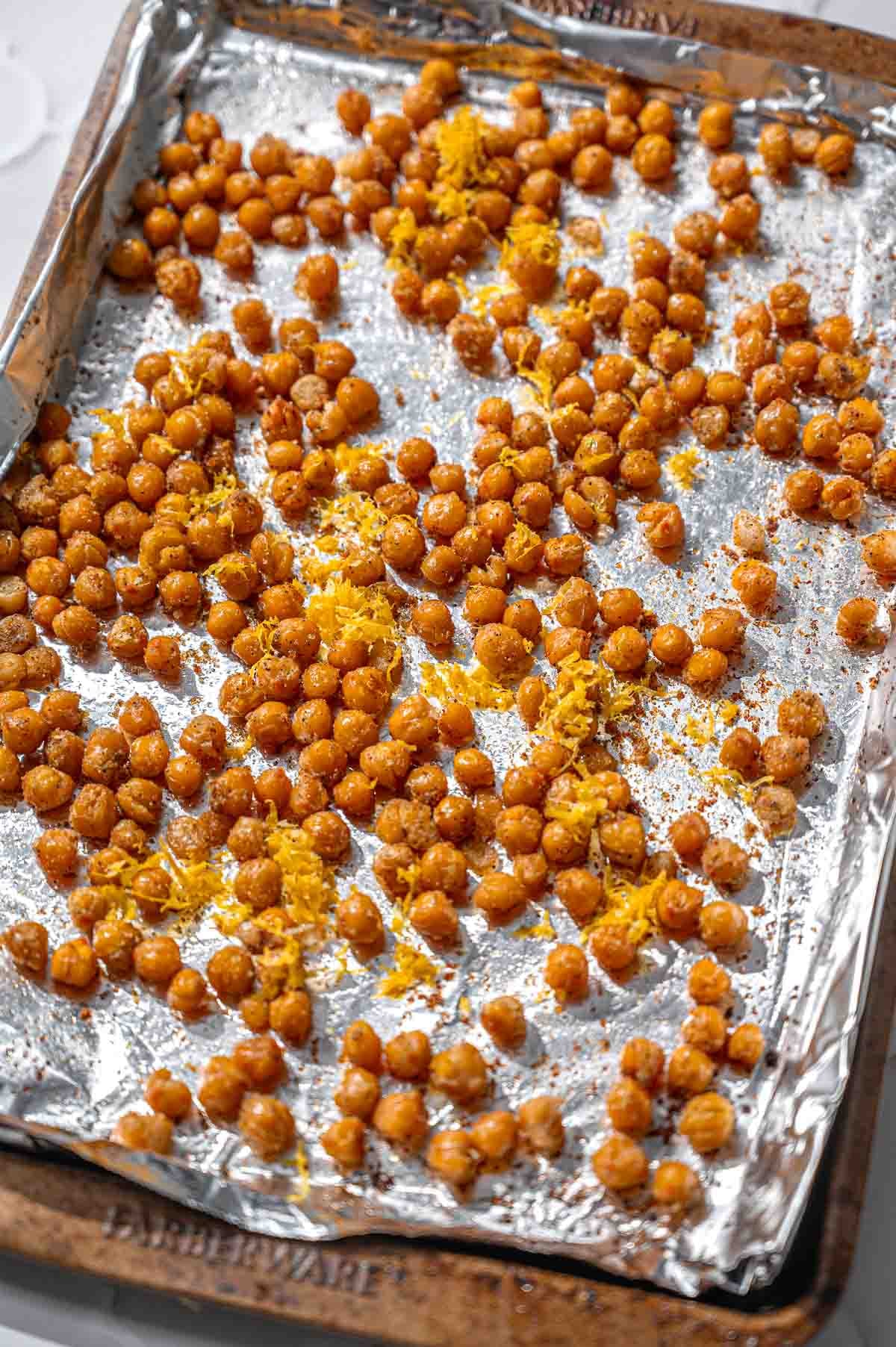 a foiled lined baking sheet with roasted chickpeas.
