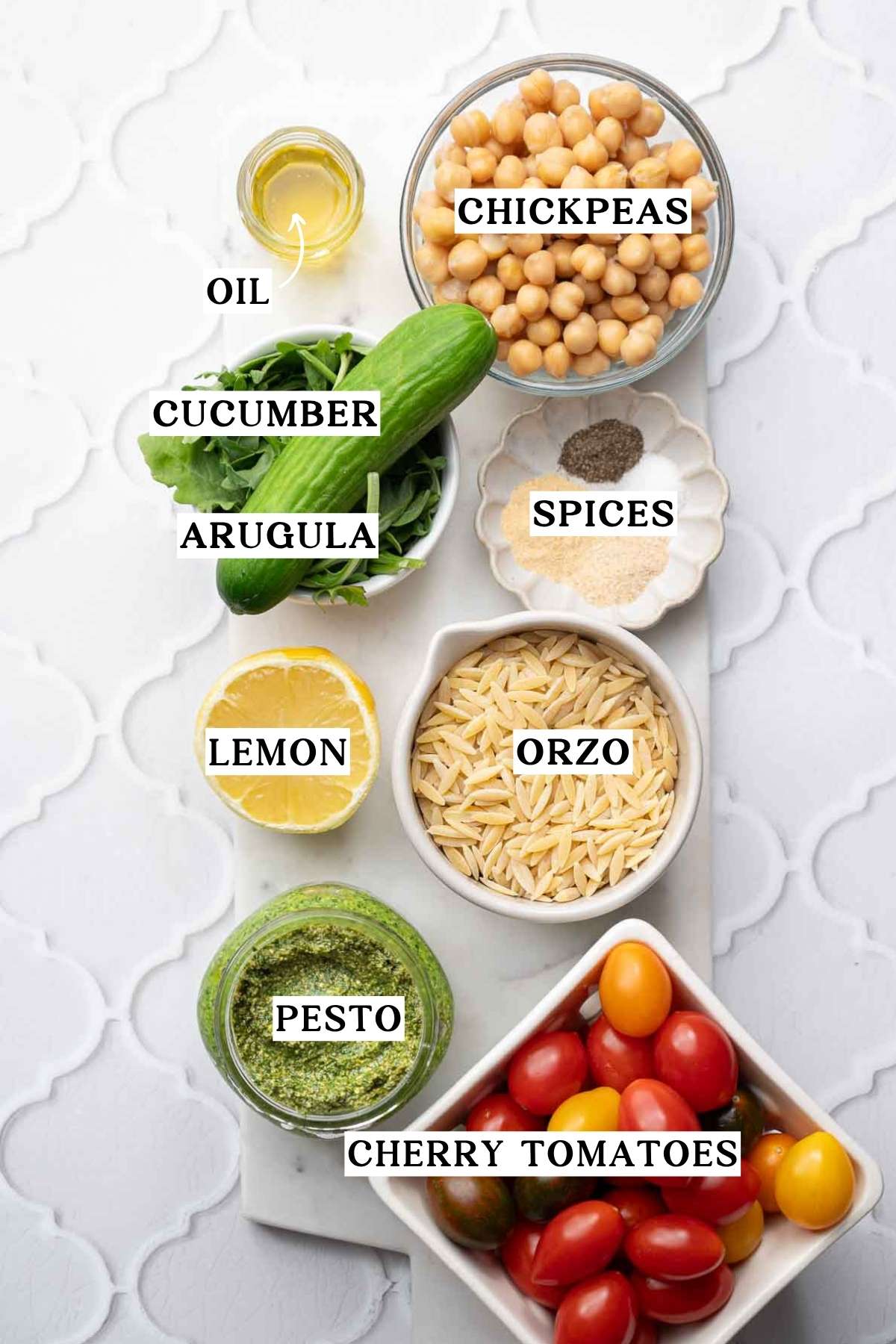 orzo, lemons, chickpeas, and veggies on a marble tray.