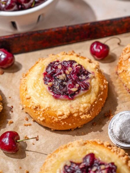 soft and fluffy custard crumb buns filled with cherries.