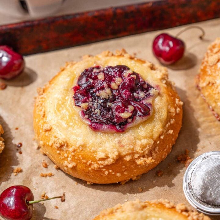 soft and fluffy custard crumb buns filled with cherries.