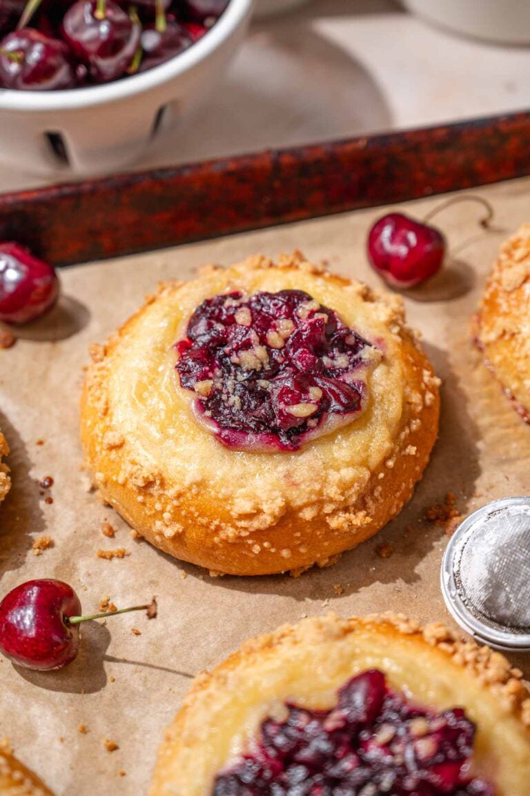 soft and fluffy custard crumb buns filled with cherries.